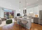 Thumbnail 1 of 32 - A modern kitchen with a large island and stainless steel appliances.