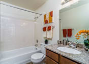 Thumbnail 21 of 23 - A bathroom with a white tub, toilet, and sink.