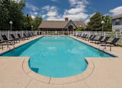 Thumbnail 10 of 23 - A large outdoor swimming pool surrounded by lounge chairs.
