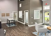 Thumbnail 7 of 37 - a living room with gray walls and a table and chairs