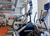 Thumbnail 9 of 41 - cardio machines in the fitness center at Ovaltine Court Apartments