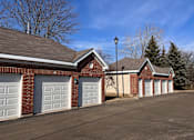 Thumbnail 44 of 47 - a row of three garage doors on a brick building