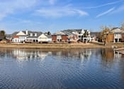 Thumbnail 45 of 47 - a body of water with houses in the background