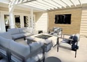 Thumbnail 8 of 21 - A patio with white furniture and a flat screen TV mounted on a wooden wall.