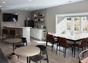 Thumbnail 3 of 21 - A modern kitchen with a dining table and chairs.