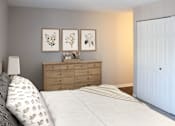 Thumbnail 15 of 21 - A bedroom with a bed, dresser, and three framed pictures on the wall.