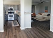 Thumbnail 25 of 41 - Modern kitchen overlooking an airy living area