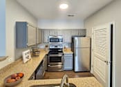 Thumbnail 23 of 41 - Kitchen with modern appliances and ample counter space