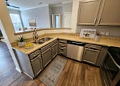 Thumbnail 24 of 41 - Designer kitchen featuring wood cabinets and stainless appliances