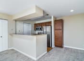 Thumbnail 19 of 23 - A kitchen with white cabinets and a white island.