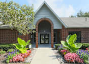 Thumbnail 1 of 23 - A building with a brick facade and a large arched entrance.