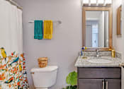 Thumbnail 25 of 37 - a bathroom with a sink and a toilet and a mirror