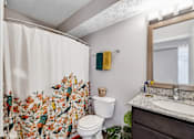 Thumbnail 26 of 37 - a bathroom with a shower and a toilet and a sink