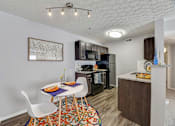 Thumbnail 16 of 37 - our apartments have a kitchen and dining area with a table and chairs