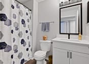 Thumbnail 23 of 37 - a bathroom with a shower and a toilet and a sink
