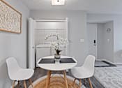 Thumbnail 18 of 37 - a dining room with a table and chairs and a laundry room