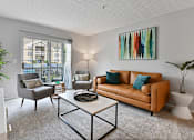 Thumbnail 19 of 37 - a living room with a leather couch and a coffee table