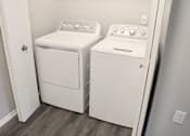 Thumbnail 29 of 37 - a washer and dryer in a room with a door