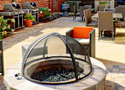 Thumbnail 14 of 41 - a fire pit on a patio with chairs and tables