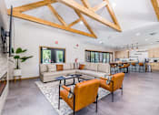 Thumbnail 5 of 23 - A modern living room with a large couch and a television.