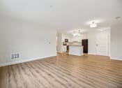 Thumbnail 29 of 36 - A large empty room with wooden floors and white walls.