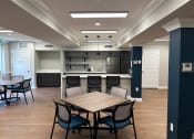 Thumbnail 13 of 32 - a dining room with a table and chairs and a kitchen