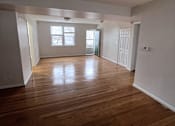 Thumbnail 25 of 29 - A room with wooden floors and white walls.