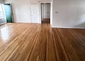 Thumbnail 27 of 29 - A room with wooden floors and white walls.