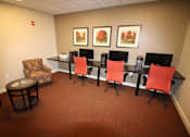 Thumbnail 8 of 9 - A conference room with a carpeted floor and a long table with chairs.
