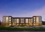 Thumbnail 3 of 43 - the building where the hotel is located is lit up at dusk