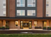 Thumbnail 2 of 43 - a rendering of a brick building with large windows