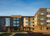 Thumbnail 1 of 43 - an exterior view of an apartment building with a parking lot