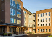 Thumbnail 6 of 43 - a large building with a street in front of it