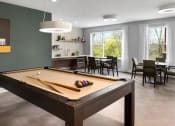 Thumbnail 20 of 43 - a pool table in a living room with a dining room and a kitchen