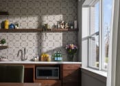 Thumbnail 19 of 43 - a small kitchen with a microwave and a table