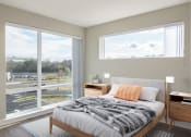 Thumbnail 11 of 43 - a bedroom with a large window and a bed with a blanket
