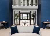 Thumbnail 22 of 43 - a living room with blue walls and a white couch