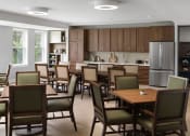 Thumbnail 23 of 43 - a large dining room with tables and chairs and a kitchen