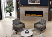 Thumbnail 21 of 43 - a living room with chairs and a fireplace