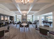 Thumbnail 2 of 7 - A large room with tables and chairs and a pool table.
