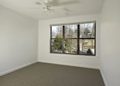 Thumbnail 14 of 16 - A room with a window and a ceiling fan.