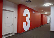 Thumbnail 12 of 16 - A hallway with a large number 3 on the wall.