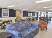 Thumbnail 9 of 15 - a room with a couch chairs and tables in it