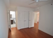 Thumbnail 15 of 15 - a bedroom with two closets and a bathroom in the background