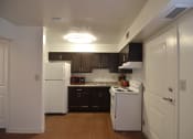 Thumbnail 8 of 15 - a kitchen with white appliances and black cabinets