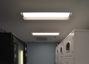 Thumbnail 5 of 15 - a row of washers and dryers in a laundry room