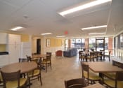 Thumbnail 3 of 15 - a common area with tables and chairs