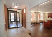 Thumbnail 1 of 15 - a view of the entrance to the leasing office with couches and chairs