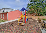 Thumbnail 16 of 32 - A playground with a slide and a wooden platform.