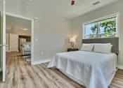Thumbnail 8 of 32 - A bedroom with a large bed and a window.